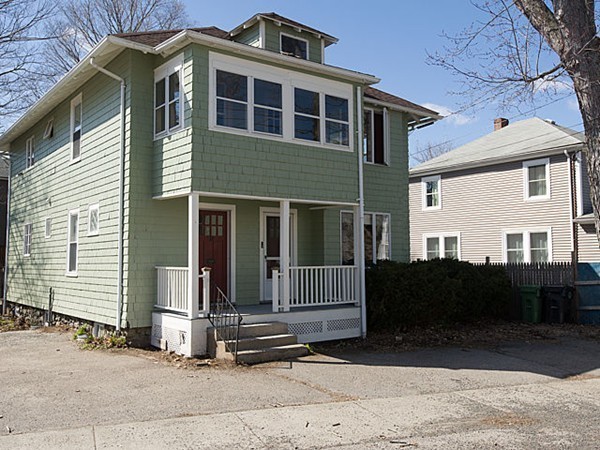 253 Sycamore Street, Unit 253 Watertown, MA 02472 - Photo 2 of 16 a front view of a house with a yard