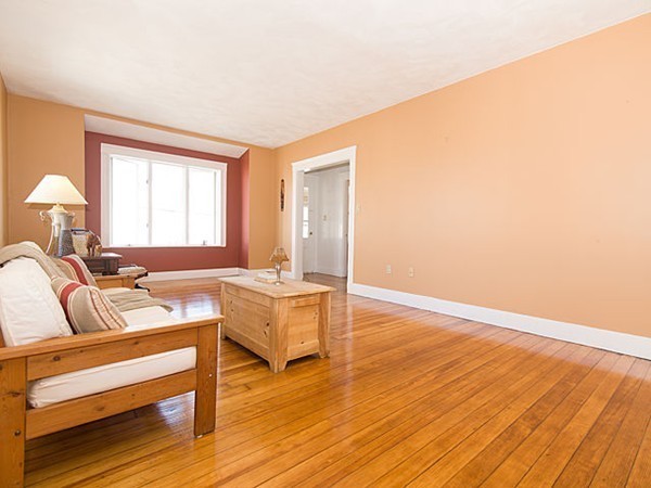 253 Sycamore Street, Unit 253 Watertown, MA 02472 - Photo 4 of 16 a living room with furniture and a wooden floor