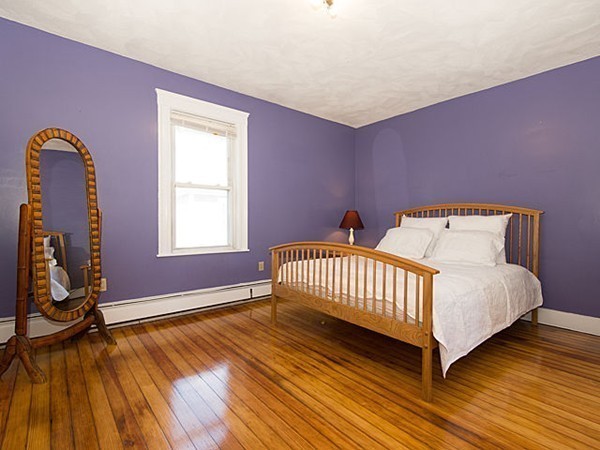 253 Sycamore Street, Unit 253 Watertown, MA 02472 - Photo 7 of 16 a spacious bedroom with a bed and wooden floor
