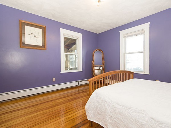 253 Sycamore Street, Unit 253 Watertown, MA 02472 - Photo 8 of 16 a bedroom with a bed and wooden floor