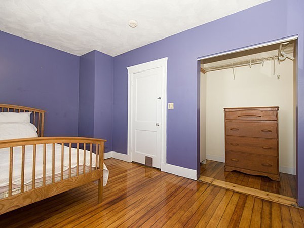253 Sycamore Street, Unit 253 Watertown, MA 02472 - Photo 9 of 16 a view of a bedroom with wooden floor