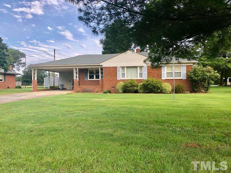 2604 Burlington Road Roxboro, NC 27574 - Photo 1 of 17 a front view of a house with a yard and trees