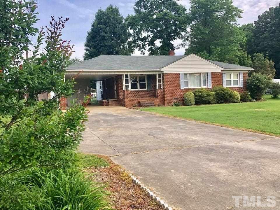 2604 Burlington Road Roxboro, NC 27574 - Photo 2 of 17 a front view of a house with a yard and porch