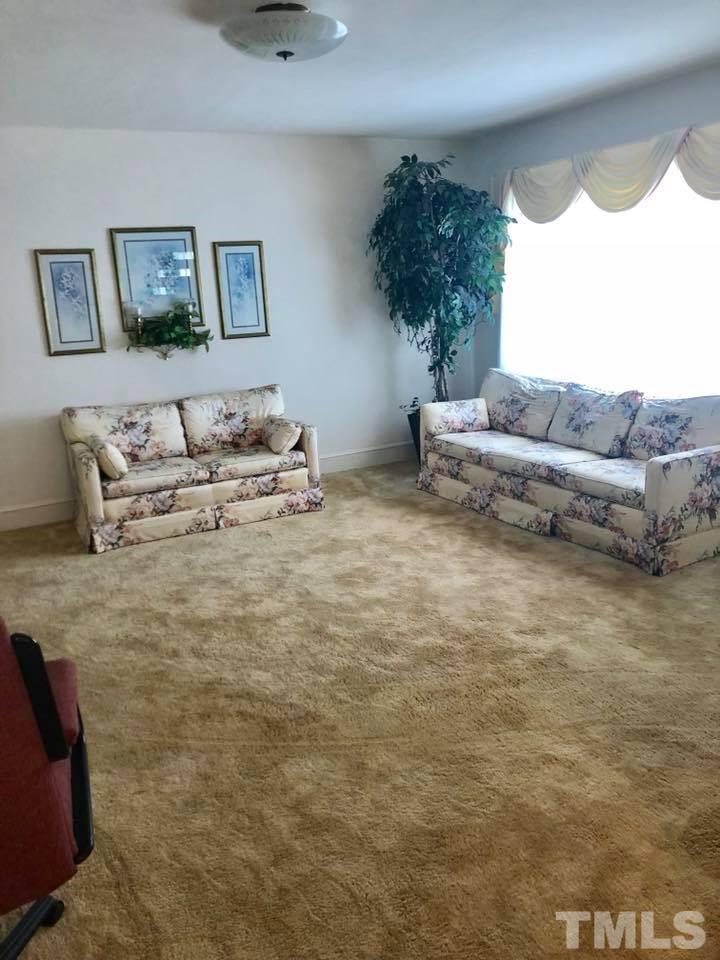 2604 Burlington Road Roxboro, NC 27574 - Photo 12 of 17 a living room with furniture and a window