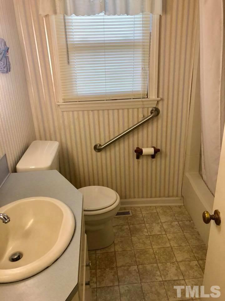 2604 Burlington Road Roxboro, NC 27574 - Photo 13 of 17 a bathroom with a sink and a toilet