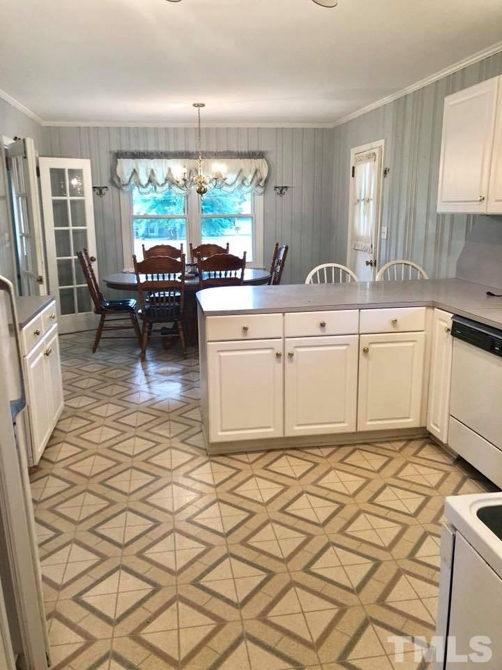 2604 Burlington Road Roxboro, NC 27574 - Photo 5 of 17 a kitchen with granite countertop a sink cabinets and window