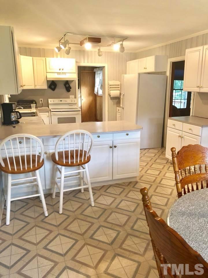 2604 Burlington Road Roxboro, NC 27574 - Photo 7 of 17 a dining room with furniture and wooden floor