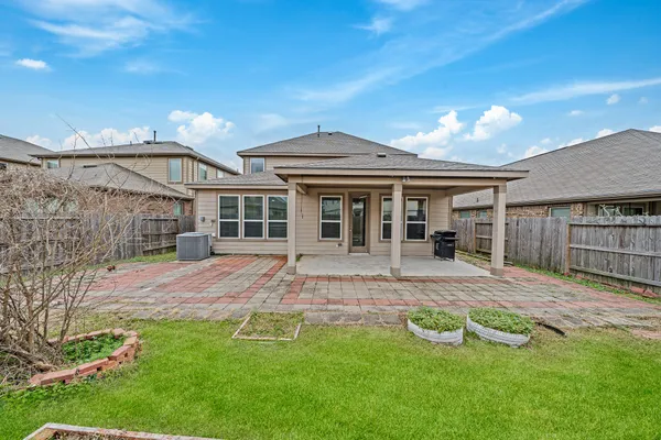 a view of a house with a yard and sitting area