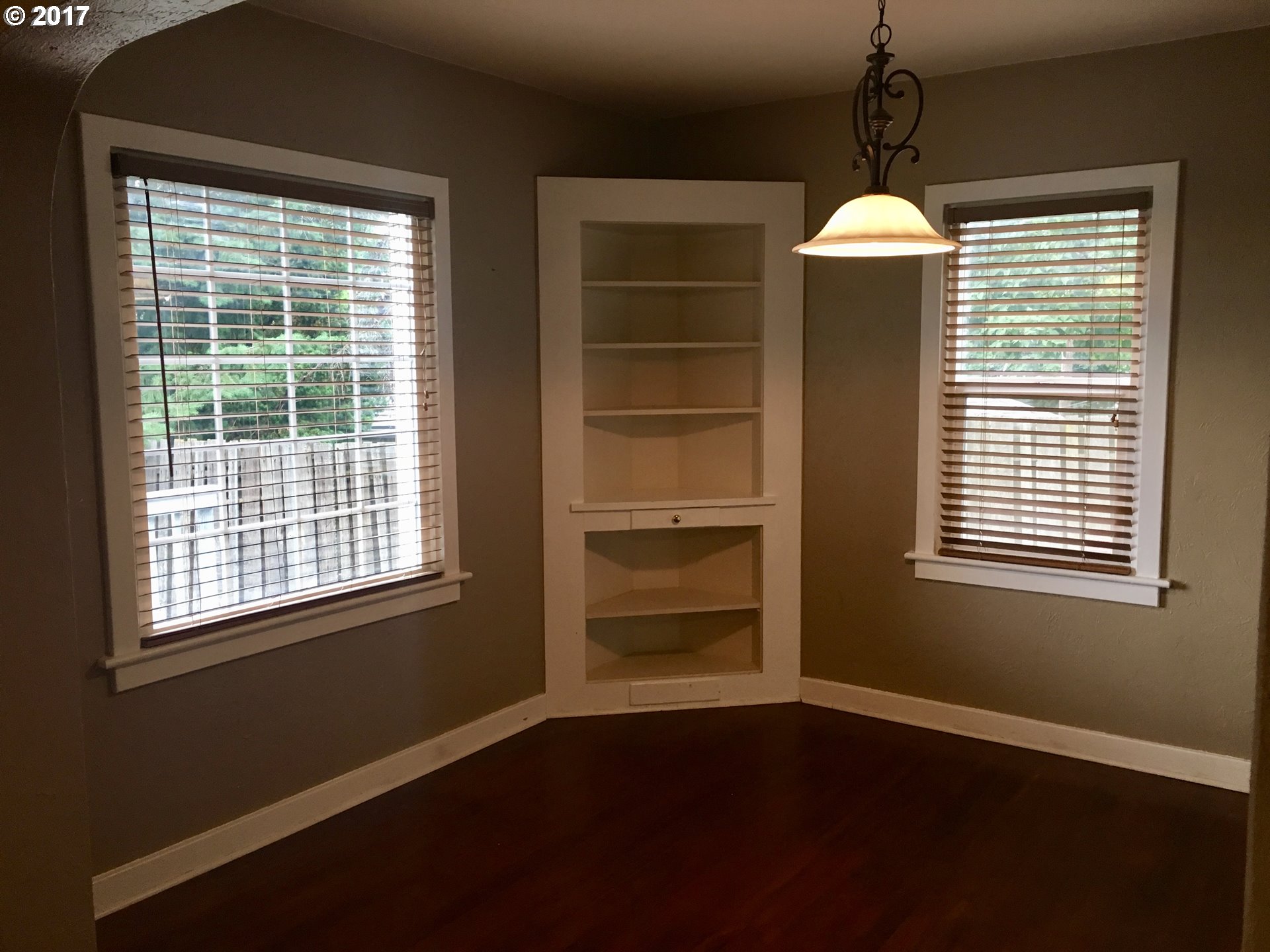 918 Southwest Goodwin Place Pendleton, OR 97801 - Photo 4 of 19 a view of an empty room with a window and wooden floor