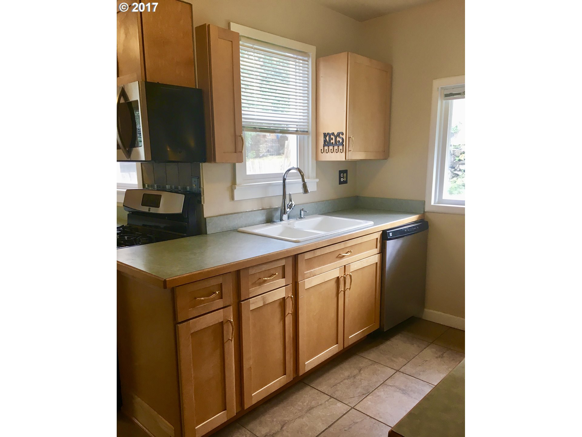 918 Southwest Goodwin Place Pendleton, OR 97801 - Photo 6 of 19 a kitchen with stainless steel appliances granite countertop a sink and a stove