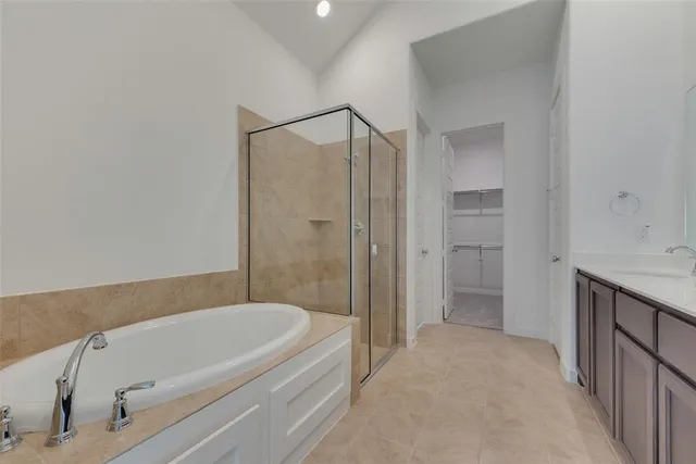 a bathroom with a tub a sink and a shower