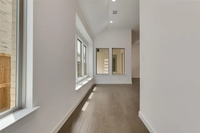 a view of a hallway with windows