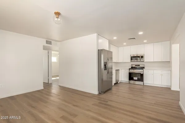a kitchen with stainless steel appliances a refrigerator and a stove top oven
