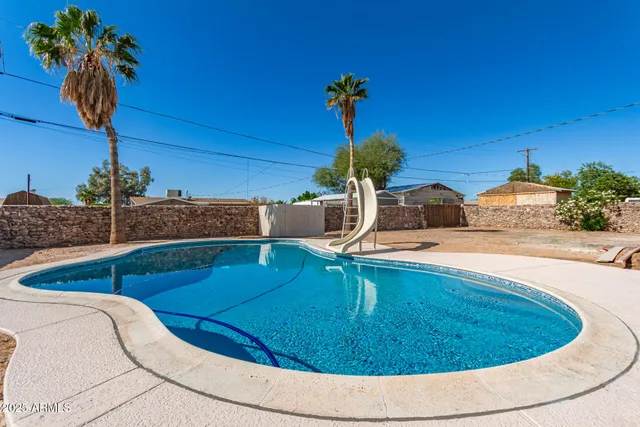 a view of a swimming pool with a house