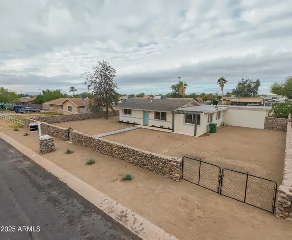 a view of a house with a yard and sitting area