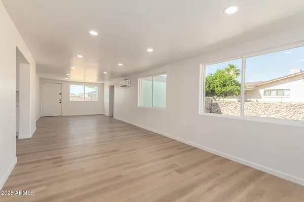 a view of an empty room with wooden floor
