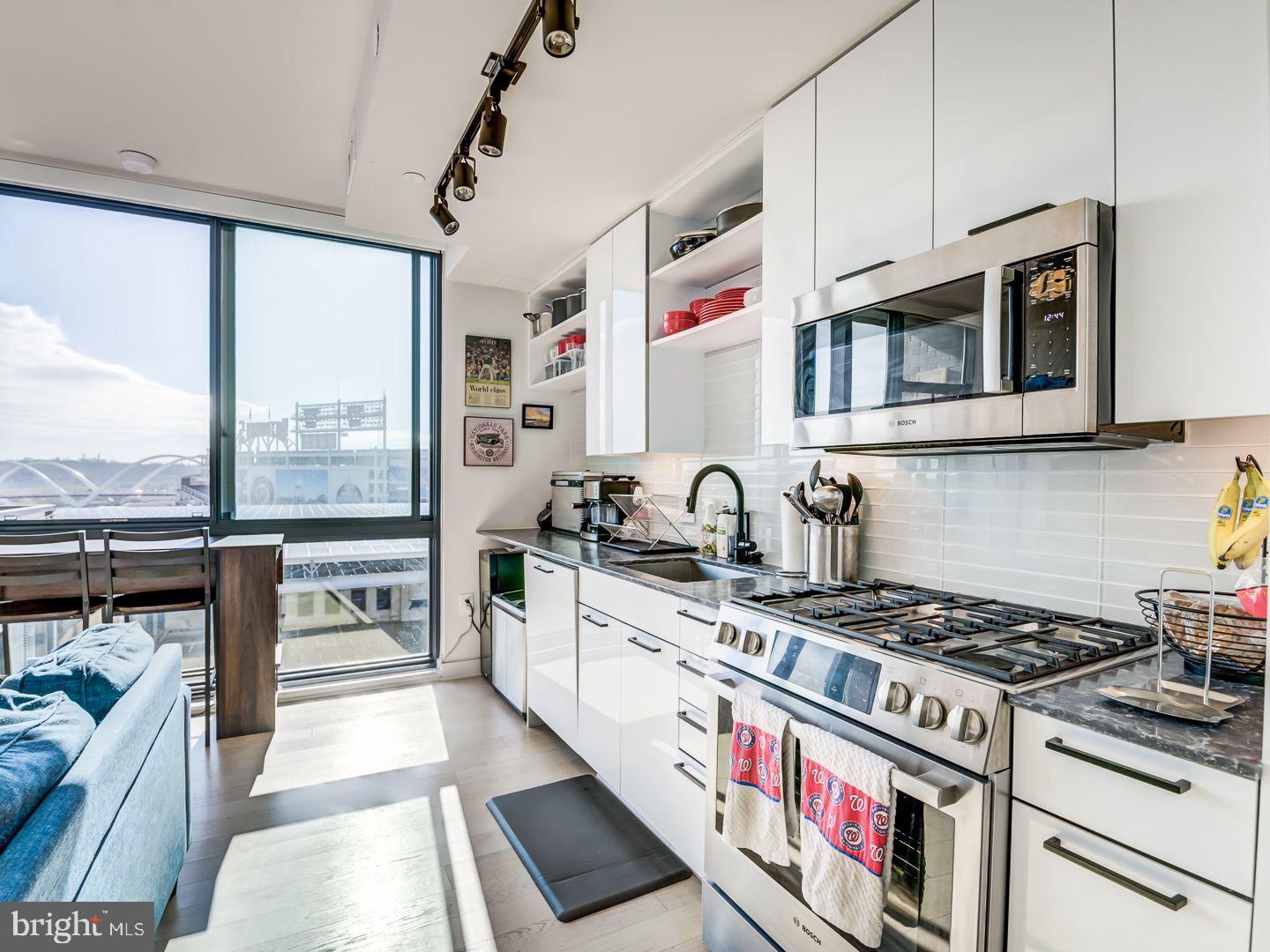 70 N Street Southeast, Unit N811 Washington, DC 20003 - Photo 5 of 28 a kitchen with stainless steel appliances granite countertop a stove and a sink