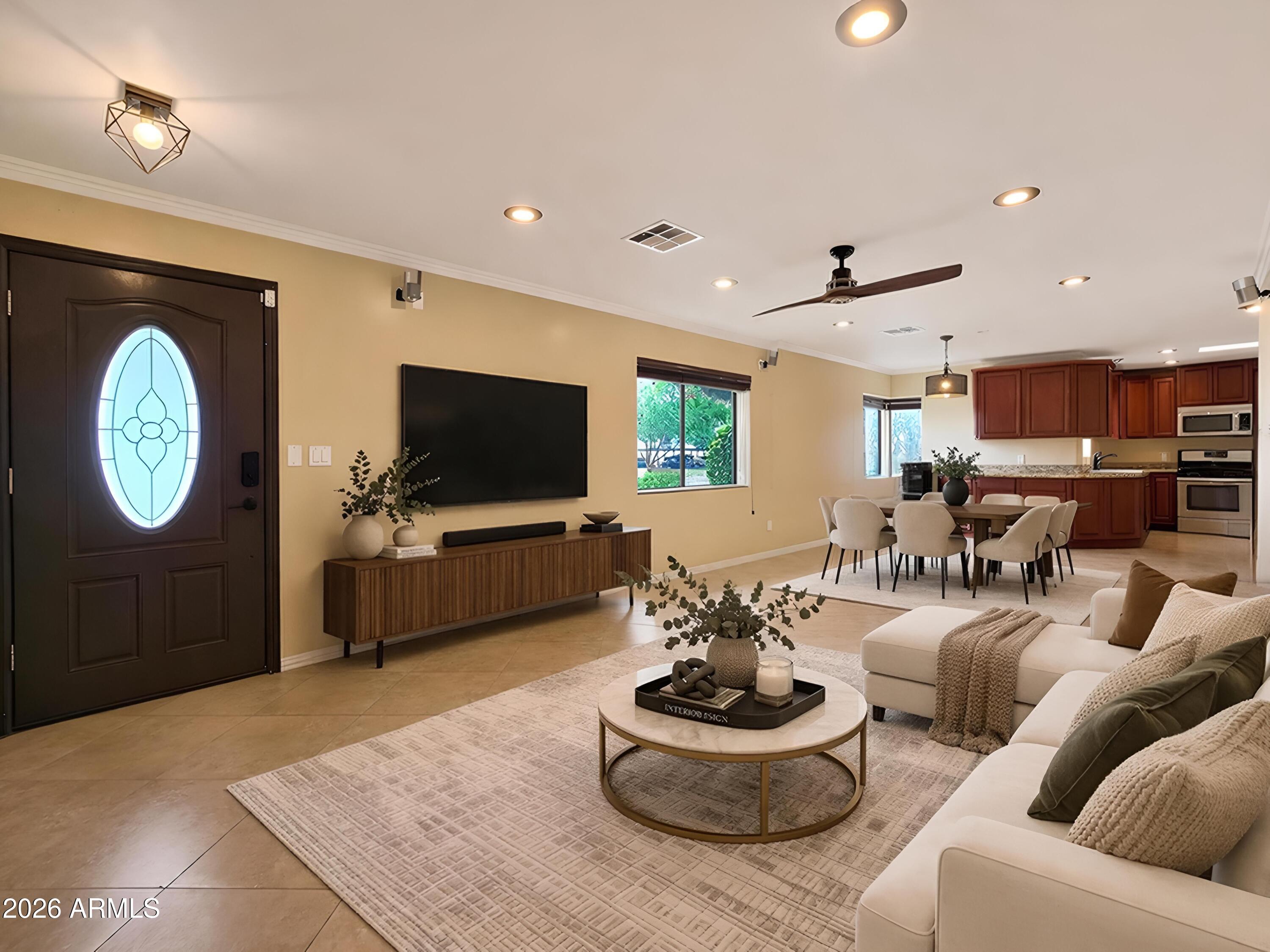 1832 West Northview Avenue Phoenix, AZ 85021 - Photo 2 of 17 a living room with furniture a clock and a flat screen tv