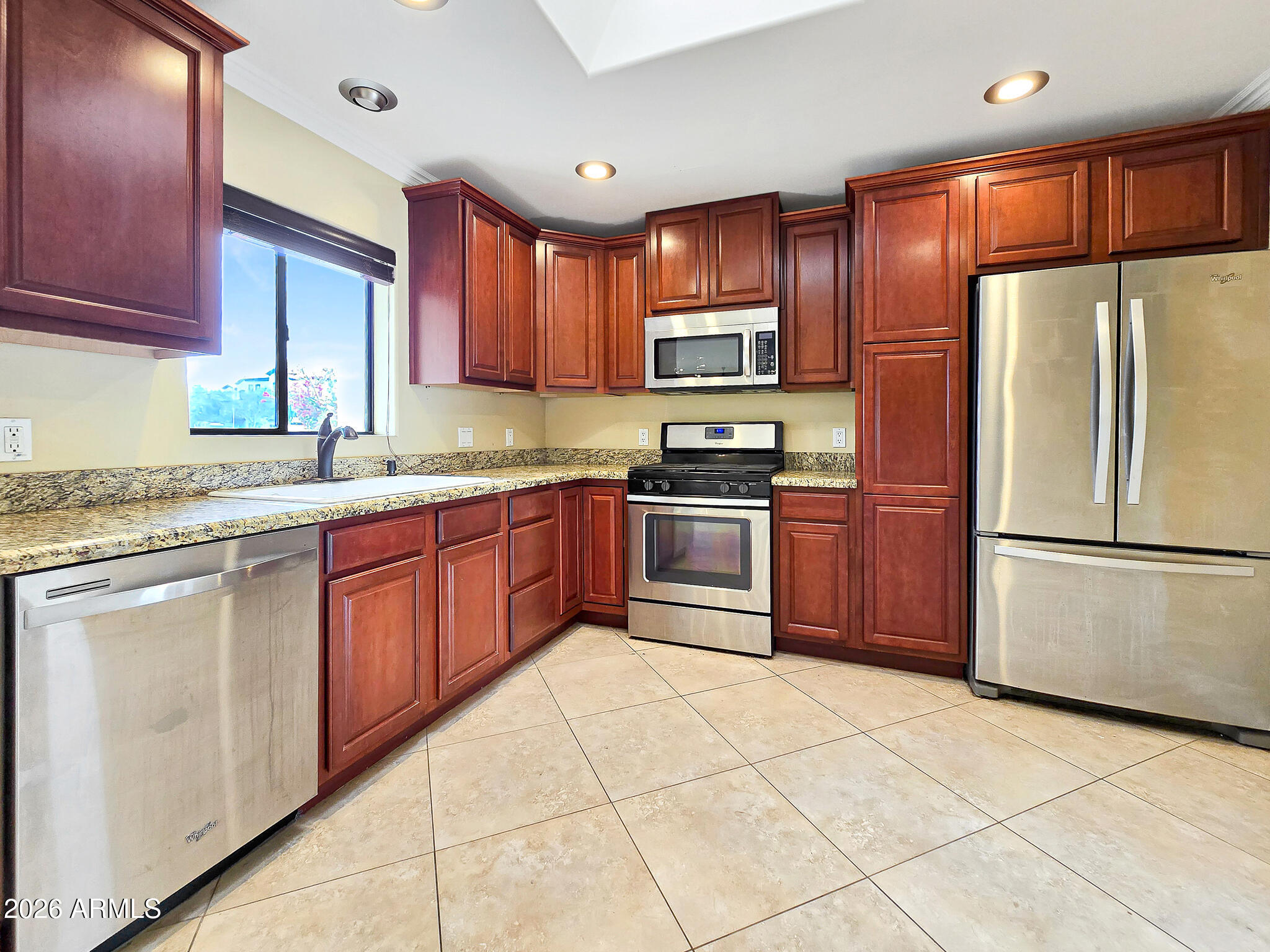 1832 West Northview Avenue Phoenix, AZ 85021 - Photo 3 of 17 a kitchen with stainless steel appliances granite countertop a refrigerator sink stove microwave and cabinets