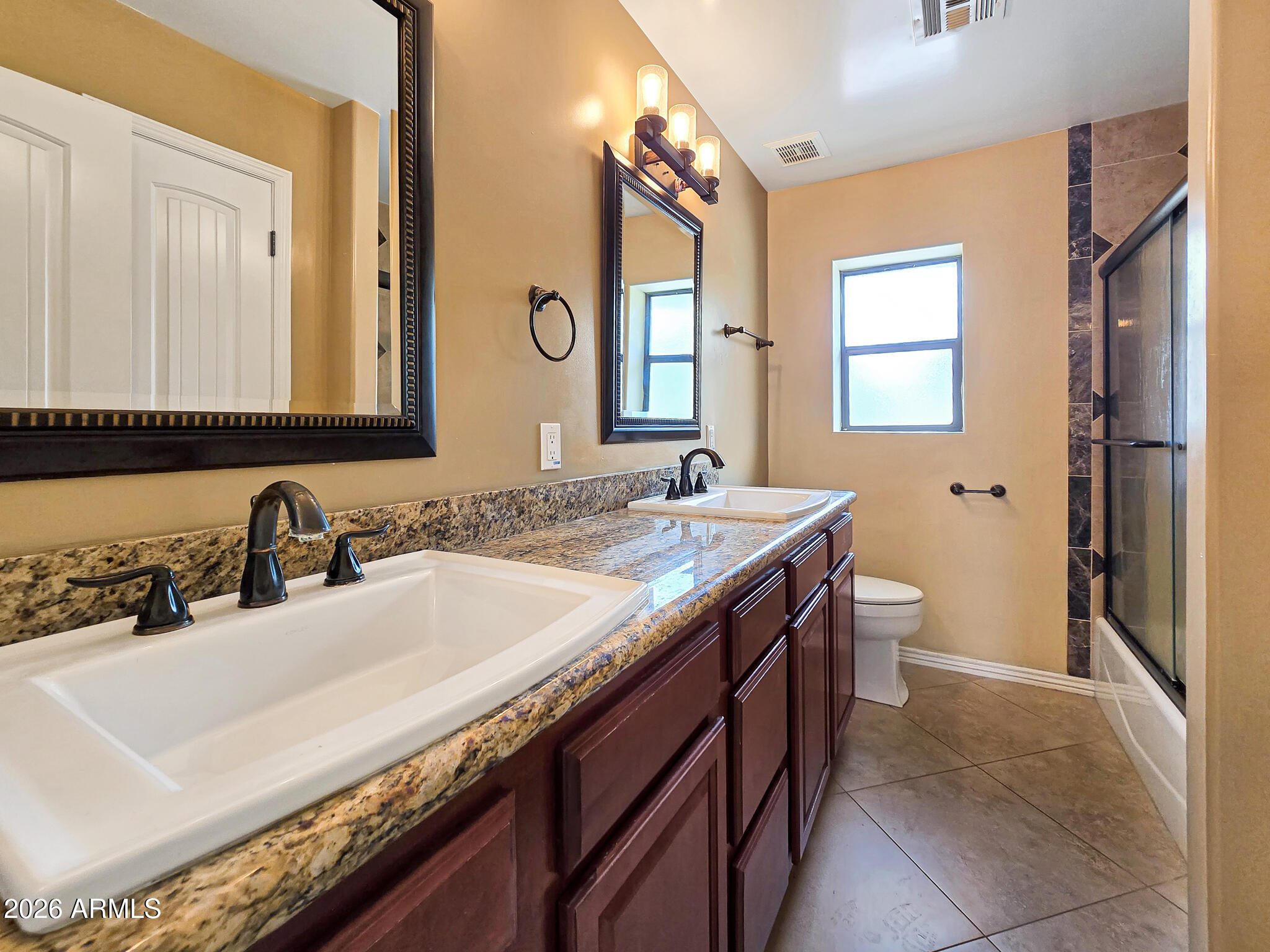 1832 West Northview Avenue Phoenix, AZ 85021 - Photo 9 of 17 a bathroom with a granite countertop sink a toilet and a mirror