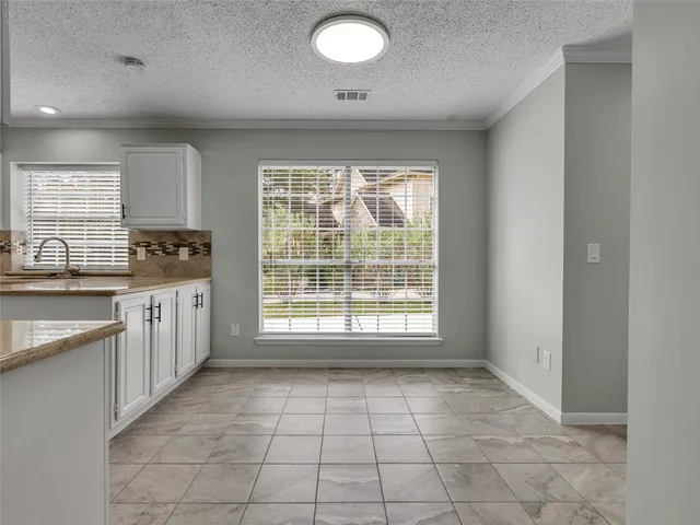 a kitchen with a stove a sink and a refrigerator