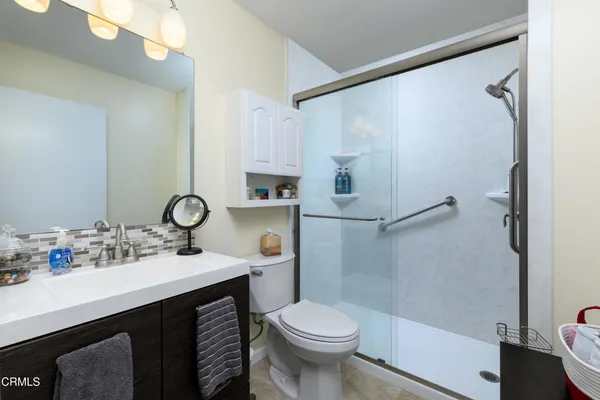 a bathroom with a sink toilet and shower