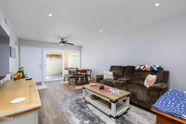 a living room with furniture and wooden floor