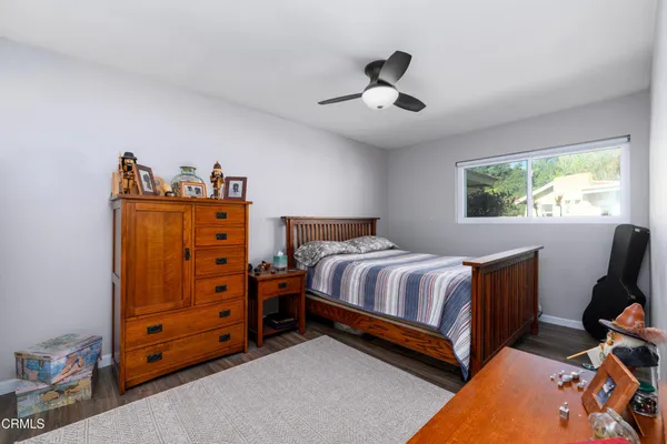 a bedroom with a bed and a dresser