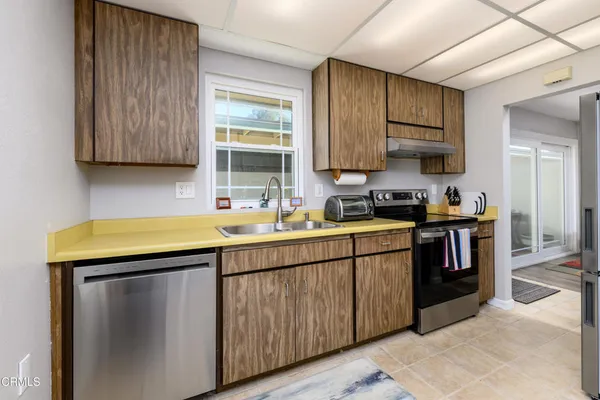 a kitchen with stainless steel appliances granite countertop a sink stove and cabinets