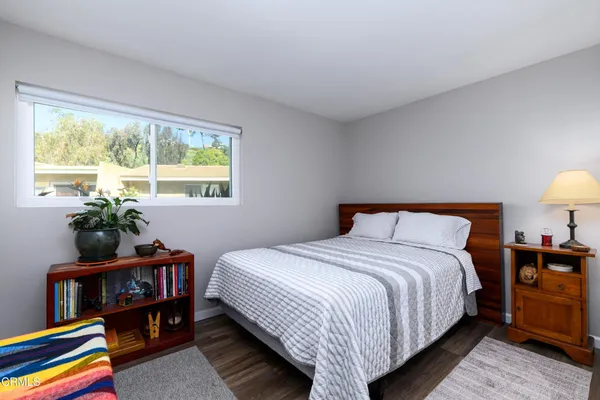 a bedroom with bed and a potted plant