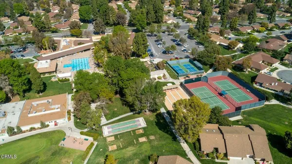 an aerial view of a house with a yard and lake view