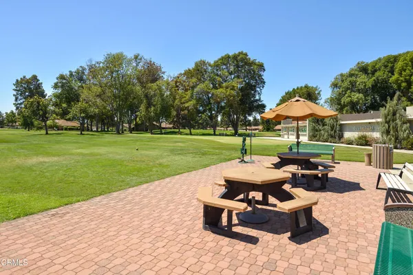 a backyard of a house with table and chairs