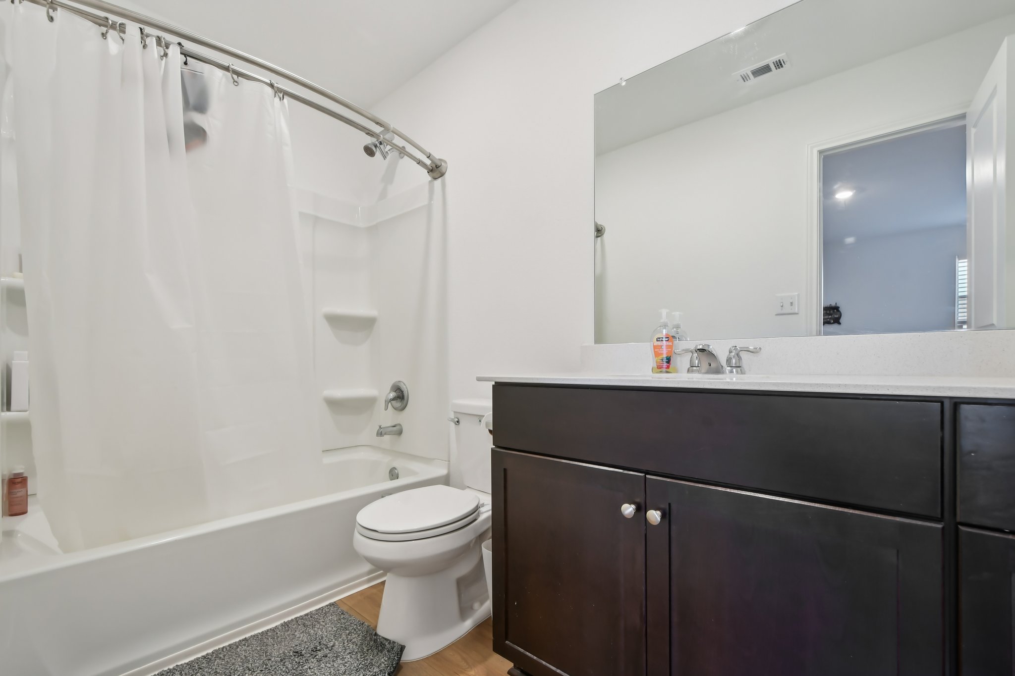 14116 Mussel Run Elgin, TX 78621 - Photo 5 of 25 Bathroom featuring vanity, shower / bath combo, and light wood-style flooring