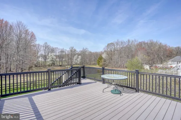 a view of balcony with wooden floor and fence