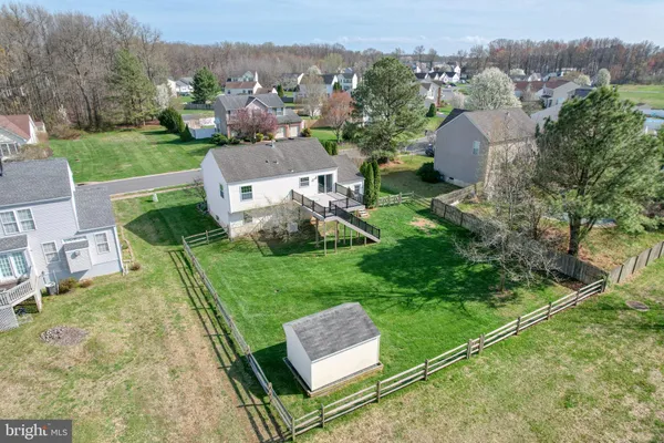 an aerial view of a house with garden space and street view