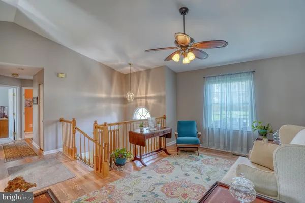 a living room with patio furniture and a chandelier