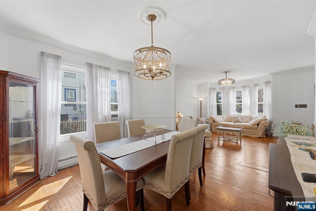 385 Berkeley Avenue Bloomfield, NJ 07003 - Photo 6 of 39 a view of a dining room with furniture wooden floor and a chandelier