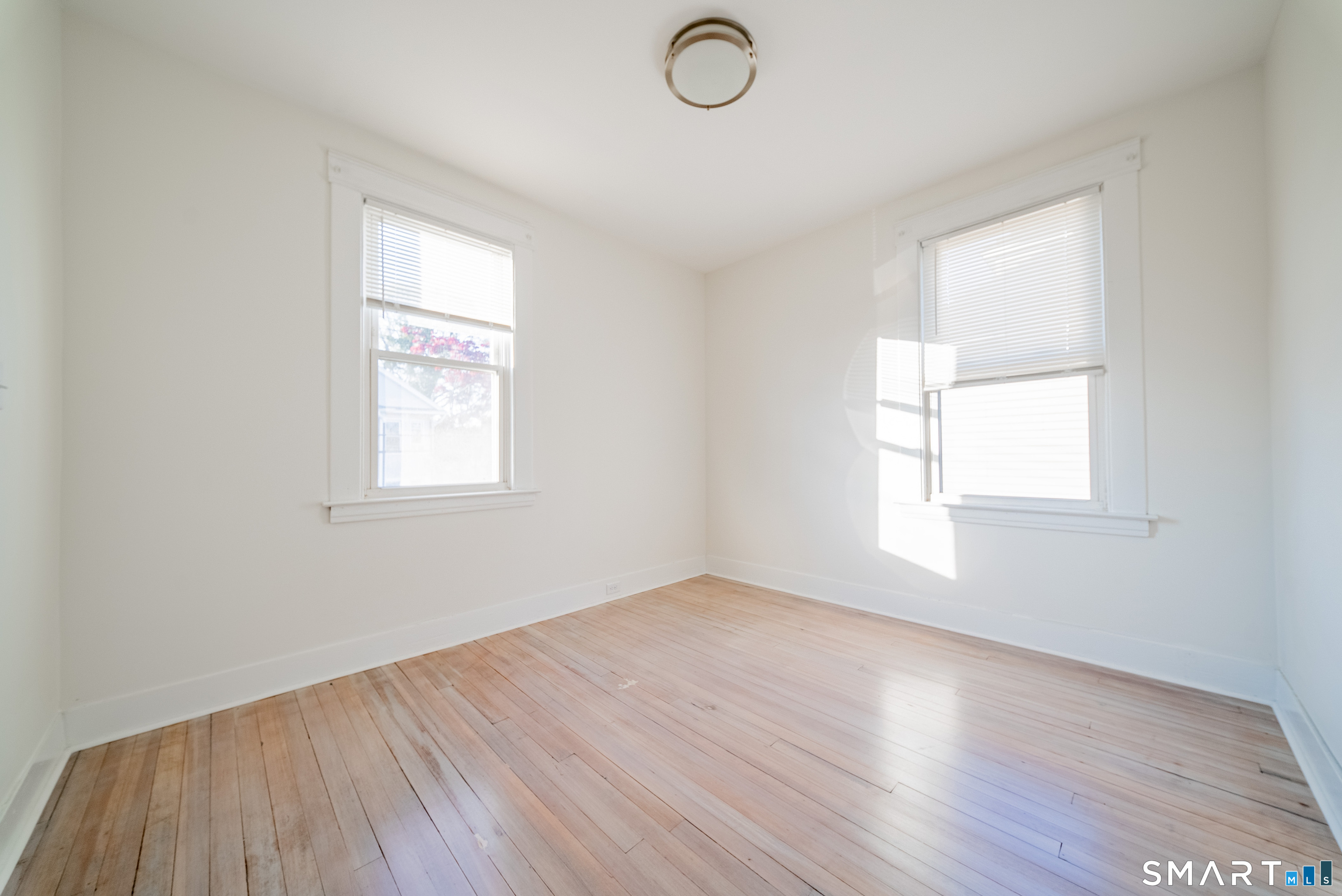 50 Jones Street West Haven, CT 06516 - Photo 15 of 21 an empty room with wooden floor and windows