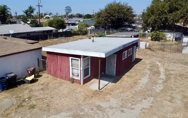 an aerial view of a house with yard and patio