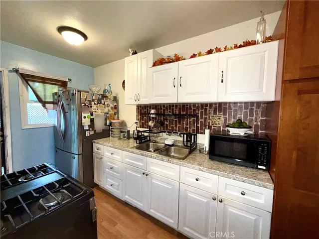 a bathroom with a granite countertop sink mirror toilet and bathtub