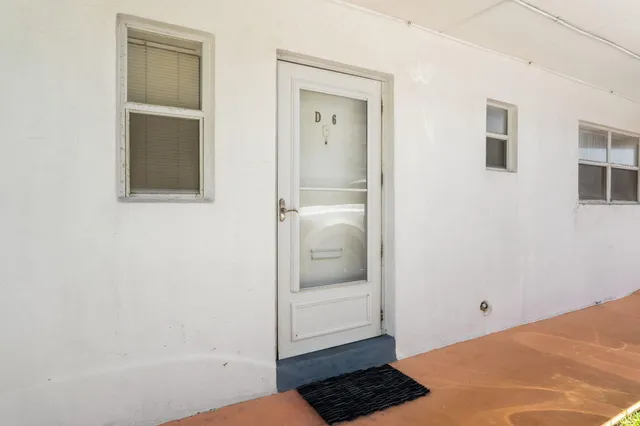 an aerial view of residential houses with yard and ocean view