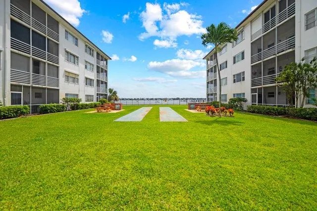 a garden with flowers and a table