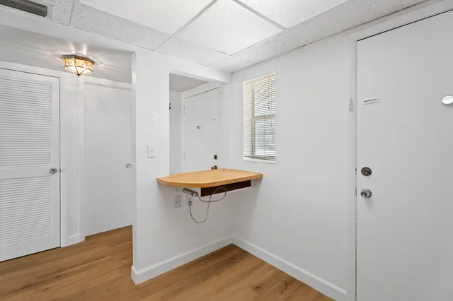 a room with pool table and a window