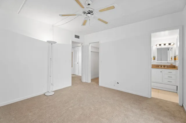 an empty room with a bathroom and a sink