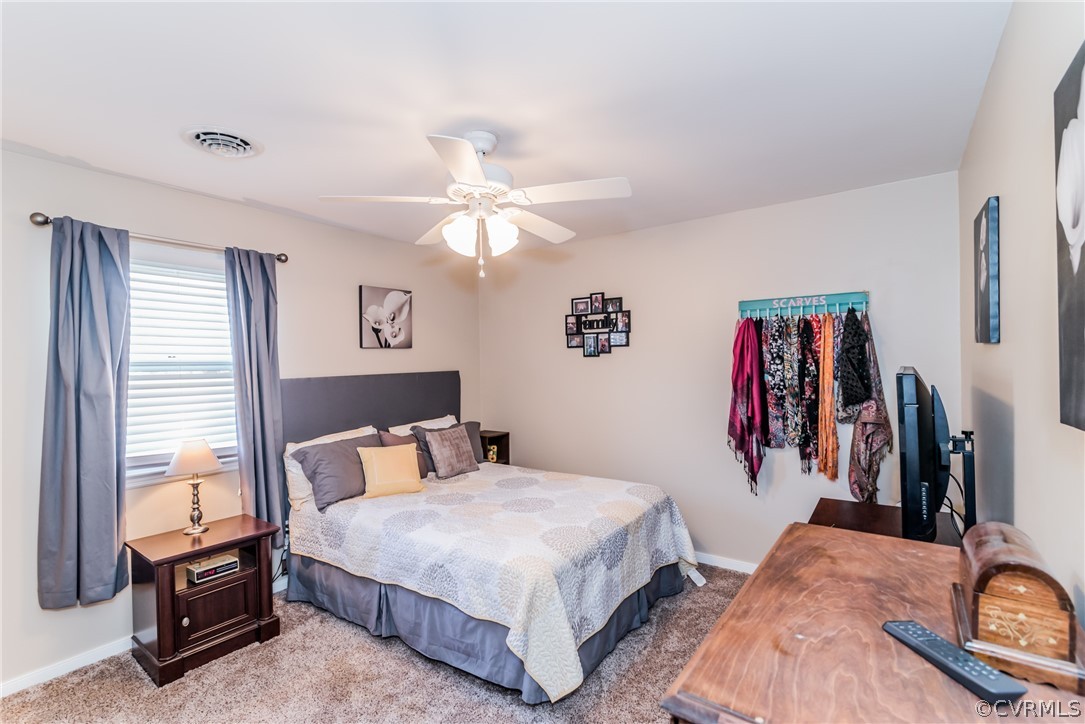 10941 River Road Chesterfield, VA 23838 - Photo 31 of 50 a bedroom with a bed and a chandelier