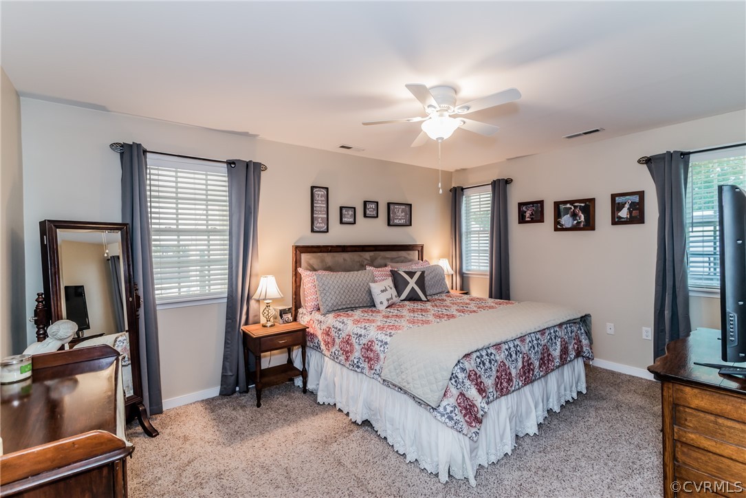 10941 River Road Chesterfield, VA 23838 - Photo 40 of 50 a bedroom with a bed and a chandelier