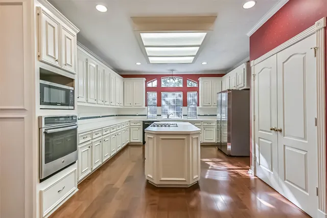 a kitchen with refrigerator and window