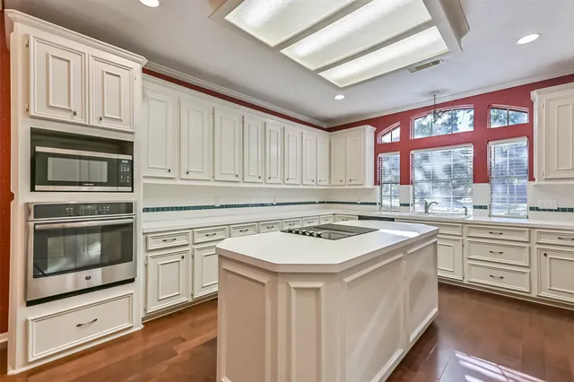 a kitchen with stainless steel appliances granite countertop a stove sink and cabinets