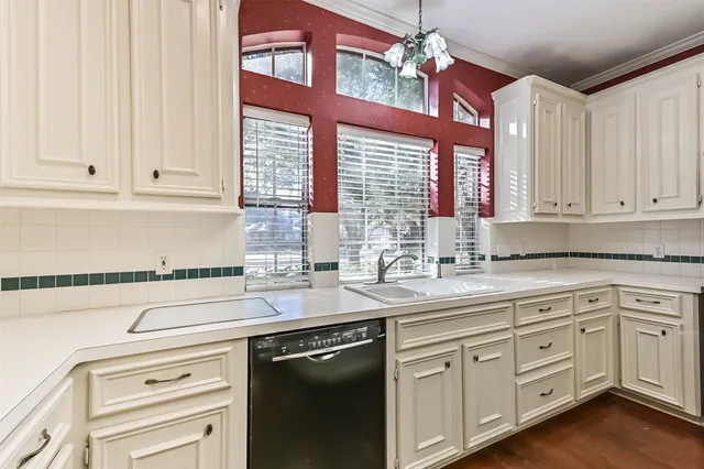 a kitchen with white cabinets and white appliances