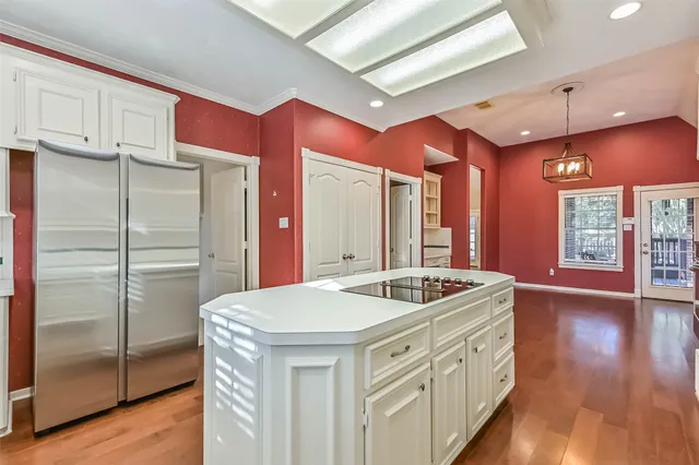 a kitchen with stainless steel appliances granite countertop a sink a refrigerator and a stove